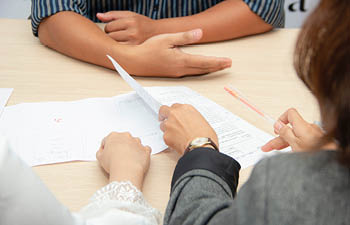 Individuals gathered around a table, discussing career opportunities.