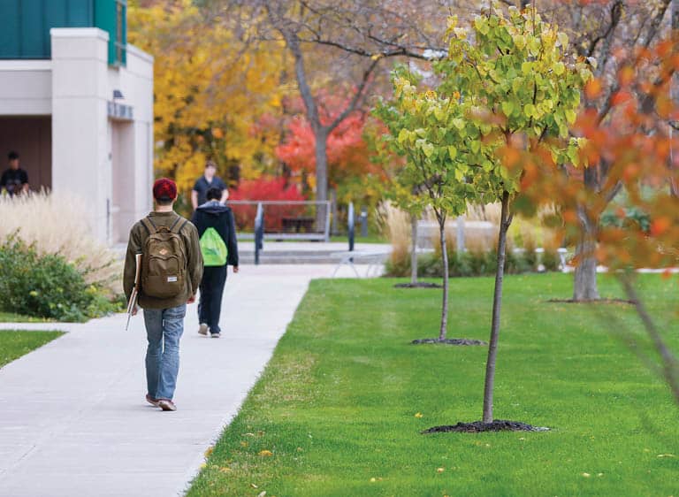 Several FLCC students walking outside FLCC Main Campus in the fall.