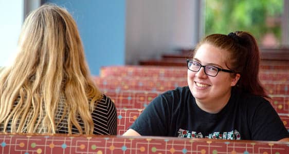 Two students relaxing in the on-campus cafe.