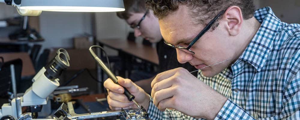 Smart Systems Technologies student building an electronic device at FLCC.